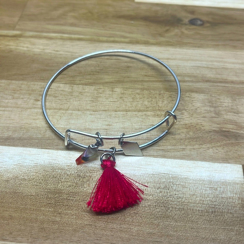 silver adjustable bangle bracelet with pink tassel and triangle charms